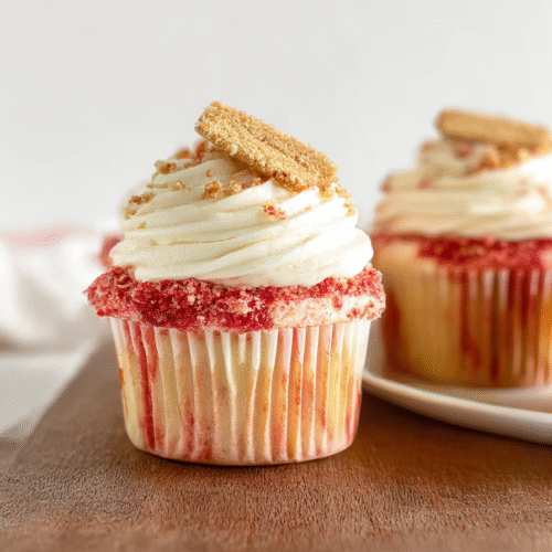 Strawberry Crunch Cupcakes topped with vanilla cream cheese frosting and Oreo strawberry crumble