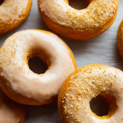 Baked pumpkin donuts with brown sugar icing and walnuts on top