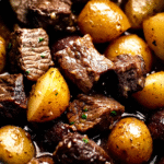 Crockpot Garlic Butter Beef Bites with Potatoes served in a bowl