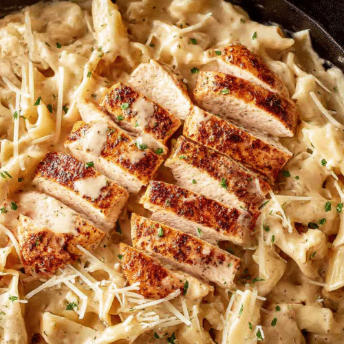 Garlic Parmesan Chicken Pasta served in a creamy sauce with parmesan and herbs.