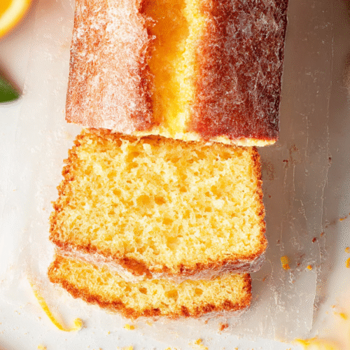 Sliced orange pound cake drizzled with citrus glaze